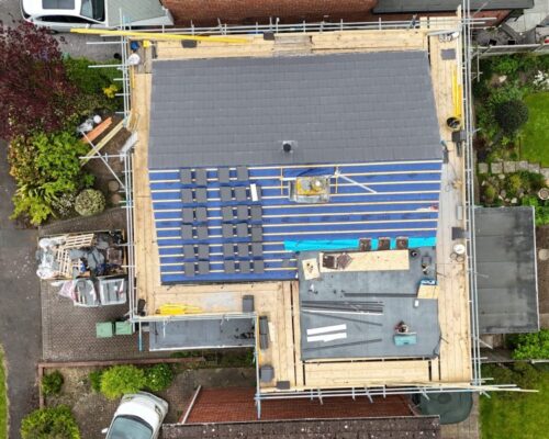 a drone photo showing a roof repair roofing project in progress
