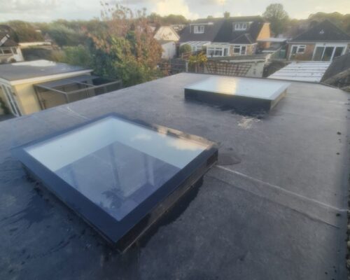 a photo showing a successful flat roof with windows installation